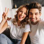 Joyful young man making selfie with his beautiful girlfriend at