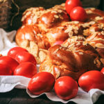 Easter,Traditional,Bread,,Greek,Tsoureki,And,Red,Eggs,On,A