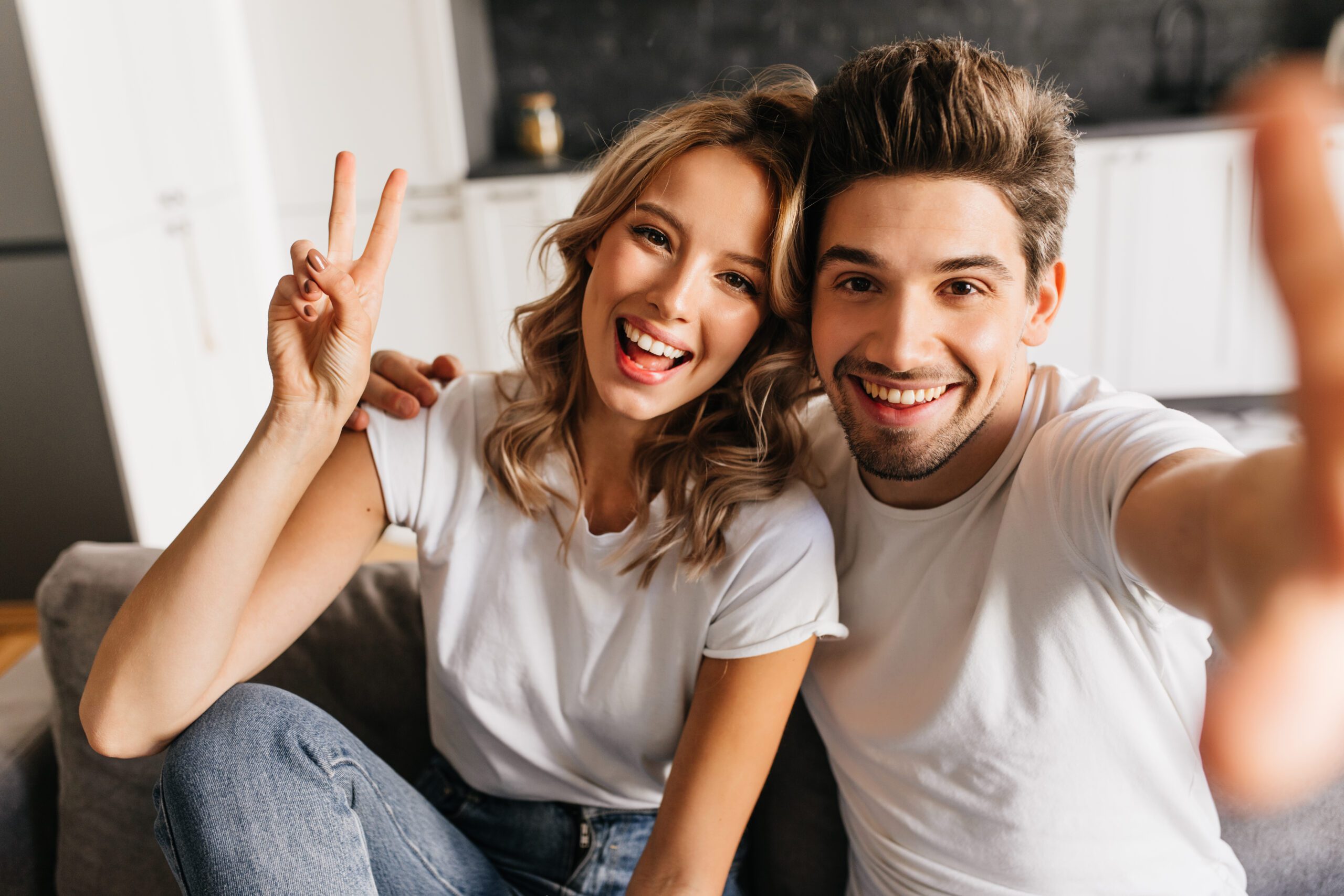 Joyful young man making selfie with his beautiful girlfriend at